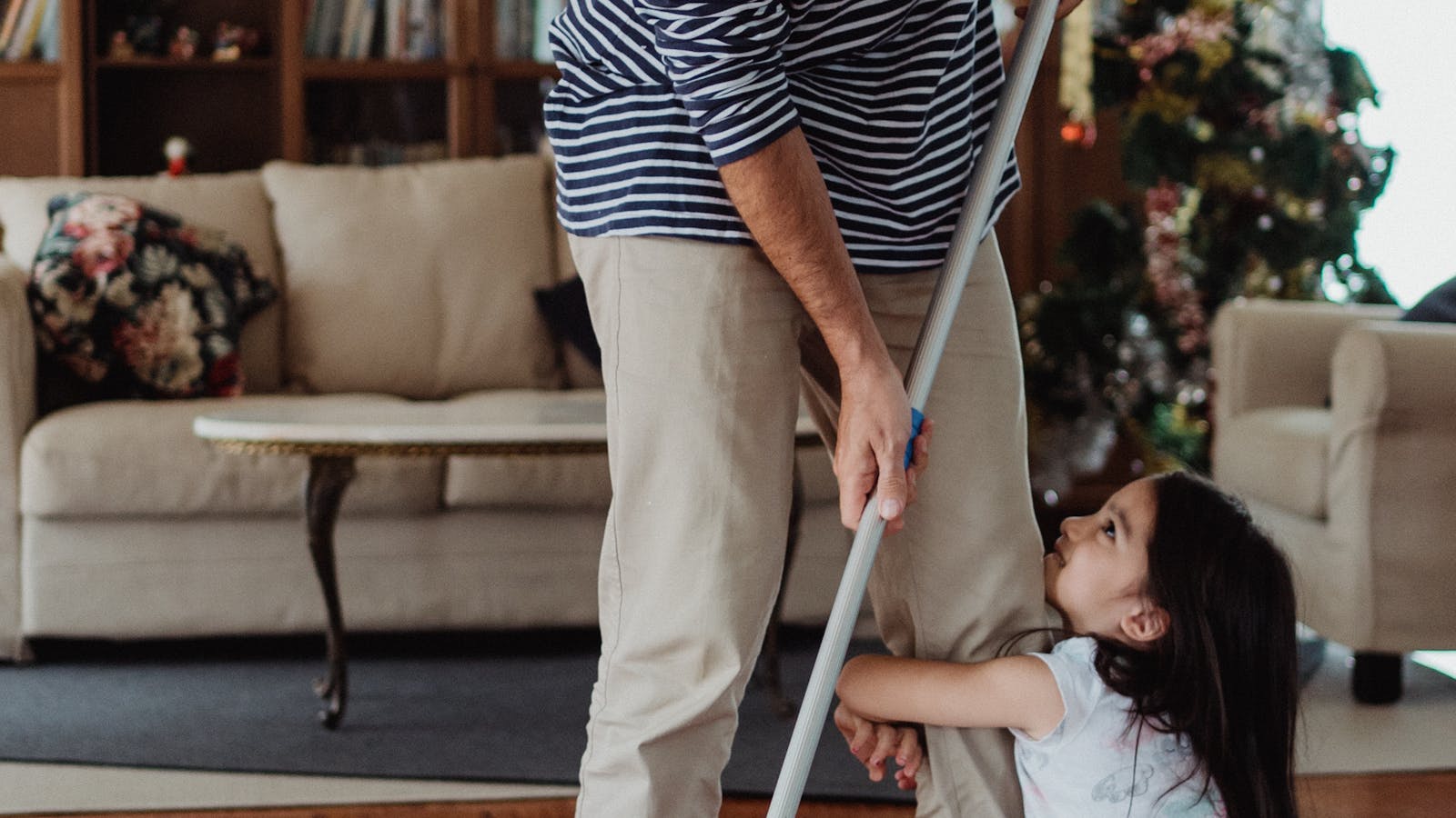 A parent cleaning the floor at home as part of household chores