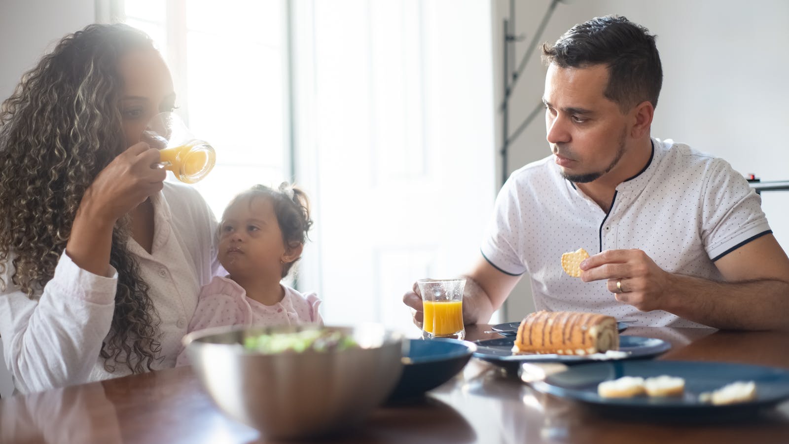 Family sharing breakfast together at a kitchen table in the morning